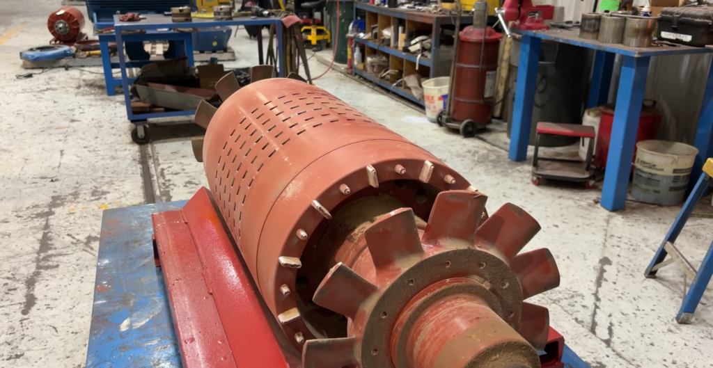 Close-up of an industrial motor being inspected in Southwest Electric's workshop for maintenance and repair.